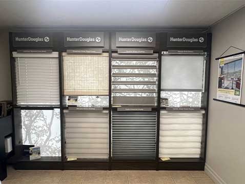 Store interior showcasing several different types of window coverings